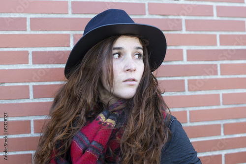 Portrait of attractive woman with hat and looking away.