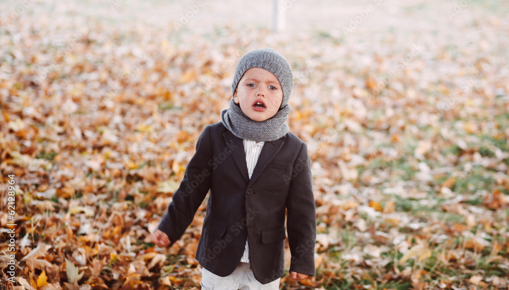emotional boy crying in autumn park emotional boy crying in autumn park