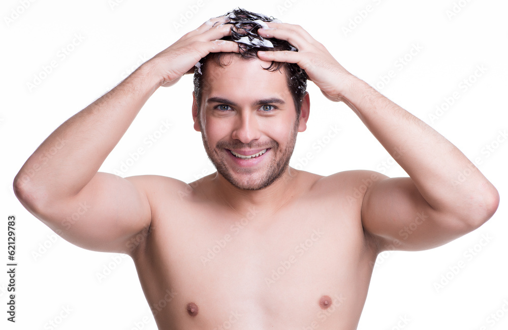 Young happy smiling man washing hair. Young happy smiling man washing hair.