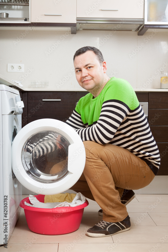 guy  doing laundry with washing machine