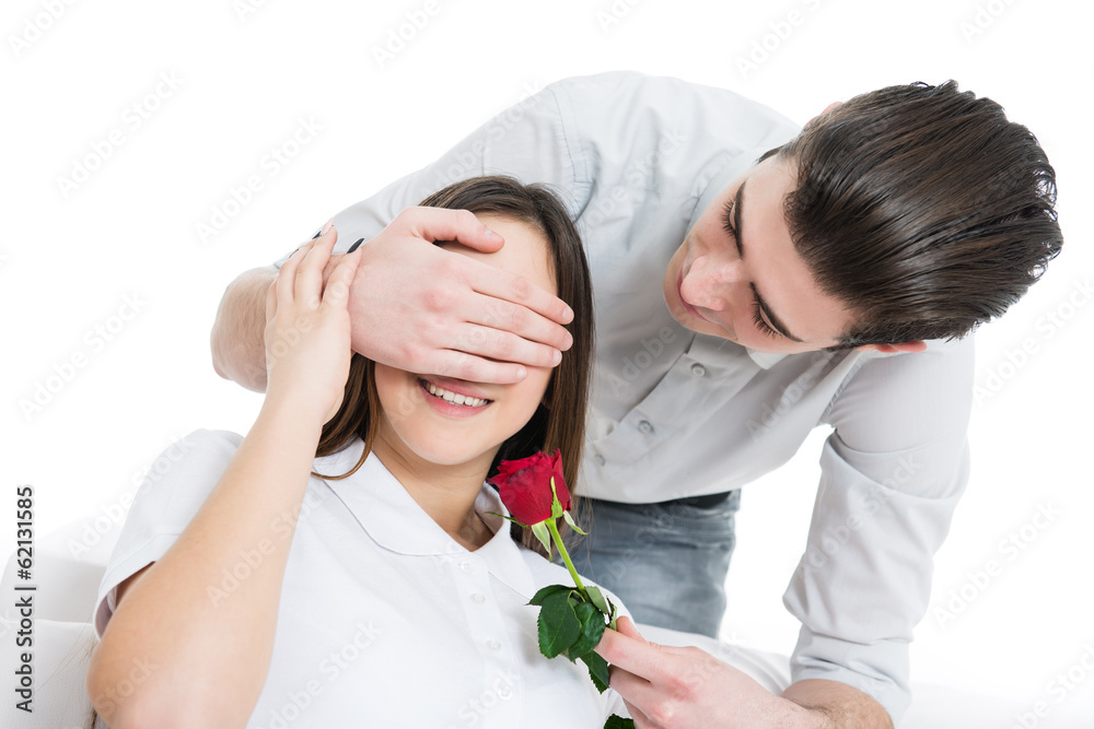 Boyfriend giving his girlfriend a bouquet of roses, close her eyes for a surprise Boyfriend giving his girlfriend a bouquet of roses, close her eyes for a surprise