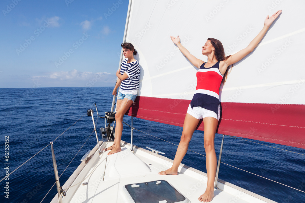 Happy women on the bow of a Sailboat.Copy space Happy women on the bow of a Sailboat.Copy space