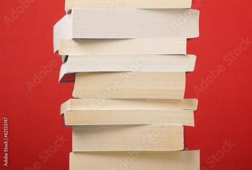 Stack of Paperback books on a red background