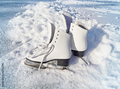 Women white skates. Abstract background on a winter sports theme