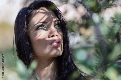 Young woman with green eyes in urban park