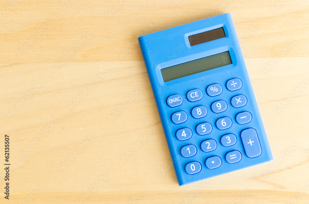 Calculator on wood table Calculator on wood table