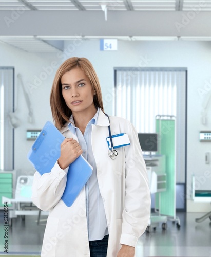 Confident female doctor in hospital room