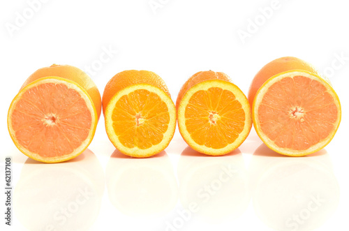 Half slices of grapefruit and oranges in a row.Isolated on white