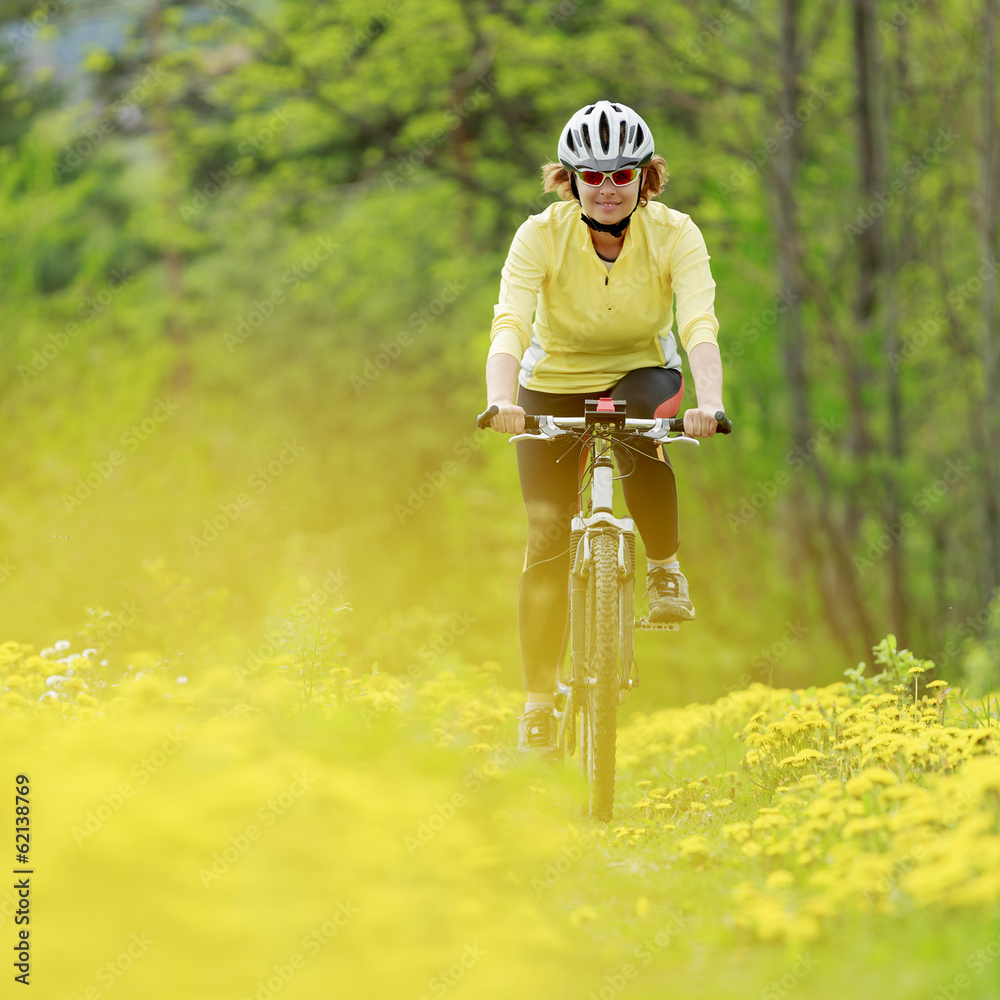 Obraz premium Bike riding - woman on bike, active adult concept