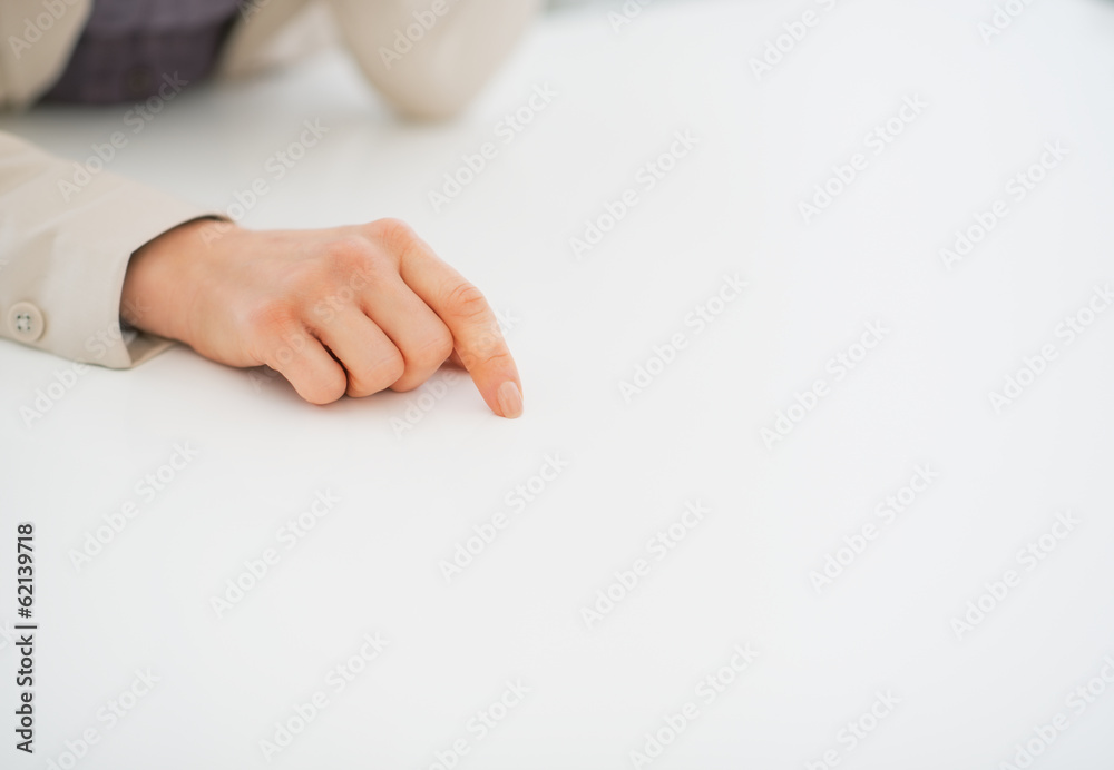 Closeup on business woman pointing on desk