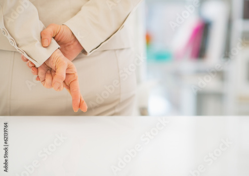 Closeup on business woman with crossed fingers