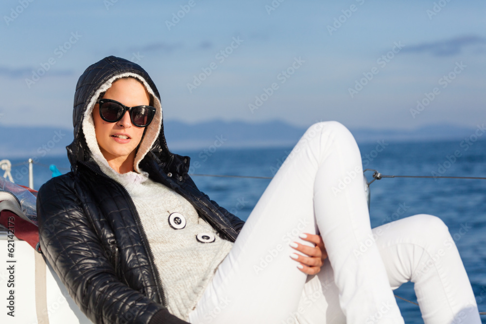 Beautiful young lady enjoying on a sailboat.Copy space