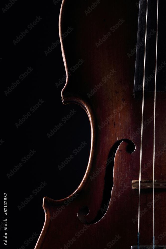 Scratched violin on dark background. Closeup view. Scratched violin on dark background. Closeup view.