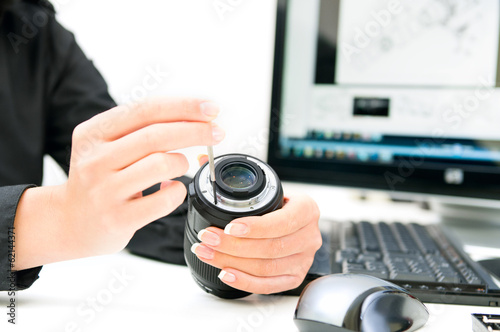 woman engineer repairing camera lens