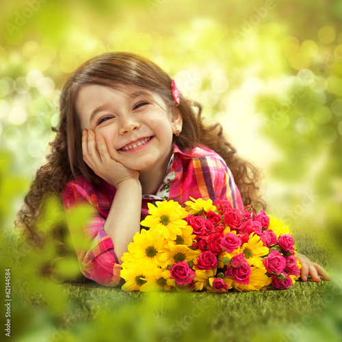 Foto Smiling girl with big bouquet of flowers