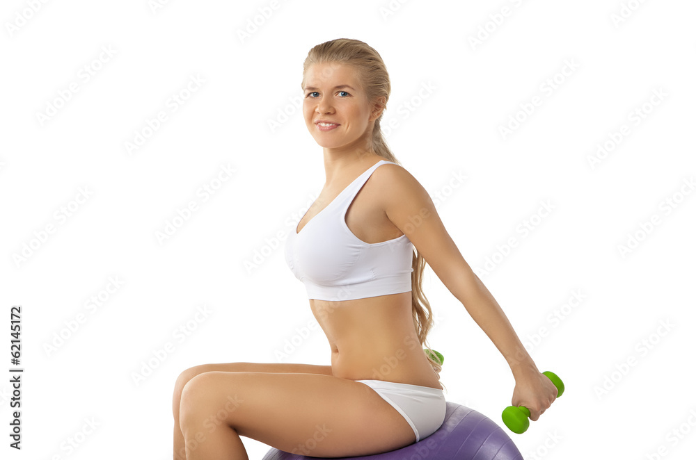 Woman exercising with dumbbells and fitball Woman exercising with dumbbells and fitball