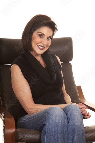 older woman black top sit chair smile close