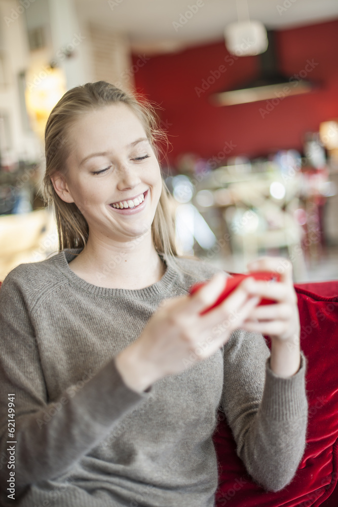 cheerful young woman sending a message on her smartphone sit on cheerful young woman sending a message on her smartphone sit on