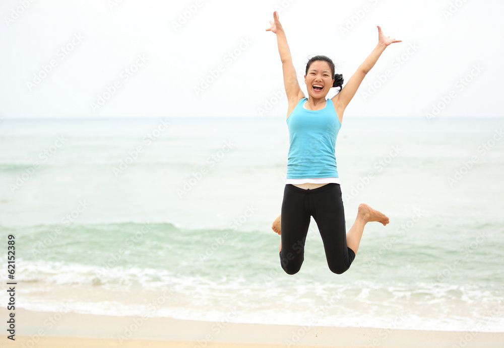 Happy woman jumping on the beach. summer holidays