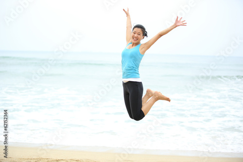 Happy woman jumping on the beach. summer holidays