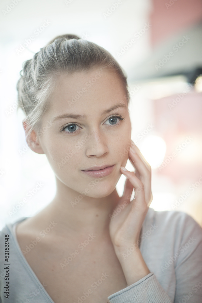 closeup of a beautiful young woman looking herself in a mirror closeup of a beautiful young woman looking herself in a mirror