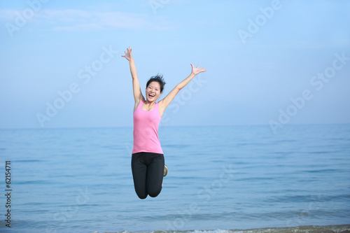 cheering woman jump at beach