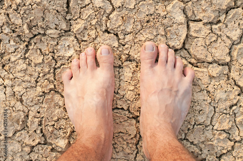 Naked Feet on dry Soil