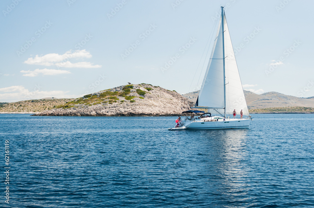 Yacht with white sail on the sea of islands,Kornati.Croatia Yacht with white sail on the sea of islands,Kornati.Croatia