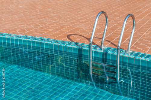Swimming pool with stainless steel ladder