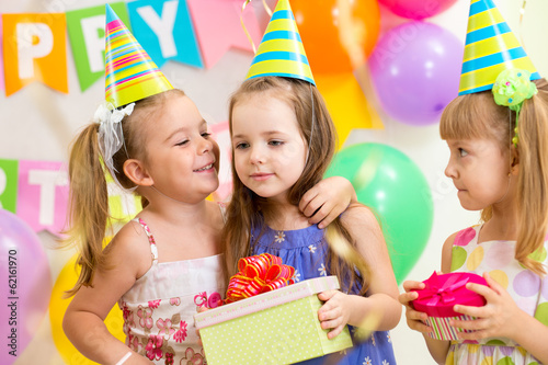 pretty children giving gifts on birthday party