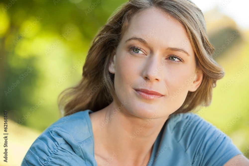 Close-up of thoughtful woman looking away in park Close-up of thoughtful woman looking away in park