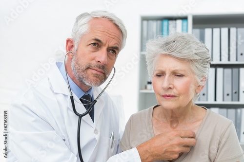 Doctor checking patients heartbeat using stethoscope