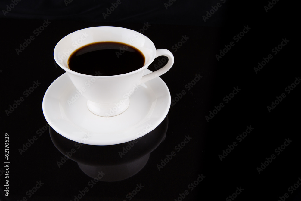 Coffee in a white cup over black background Coffee in a white cup over black background