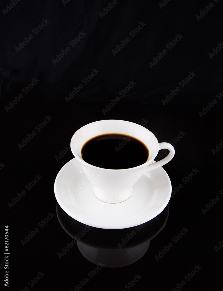 Coffee in a white cup over black background Coffee in a white cup over black background