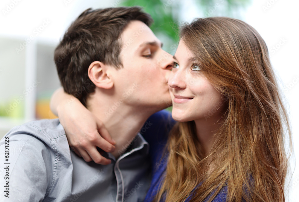 Handsome young man embracing his girlfriend with love Handsome young man embracing his girlfriend with love