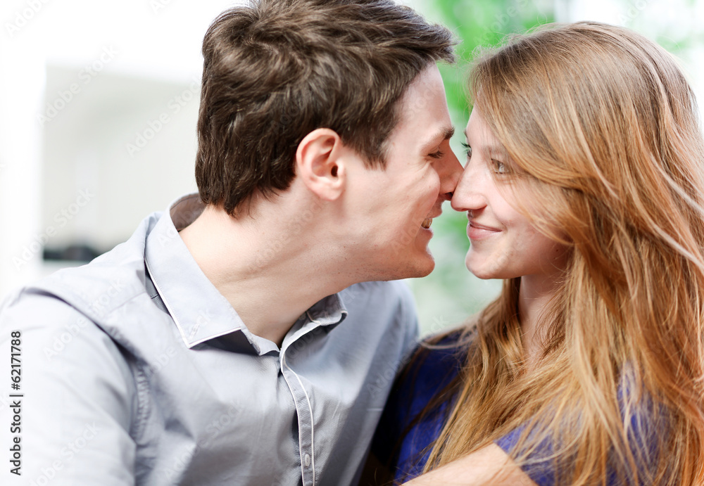 Very attractive young couple flirting on a sofa Very attractive young couple flirting on a sofa