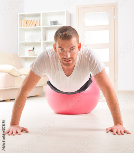 Handsome man doing push ups on the gym ball © Monika Wisniewska