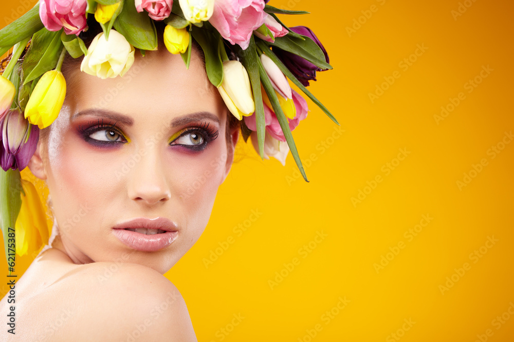 Portrait of a beautiful spring girl wearing flowers hat. Studio - obrazy, fototapety, plakaty 