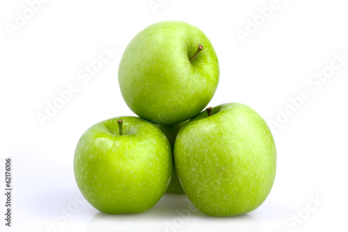 Three green apples on a white background