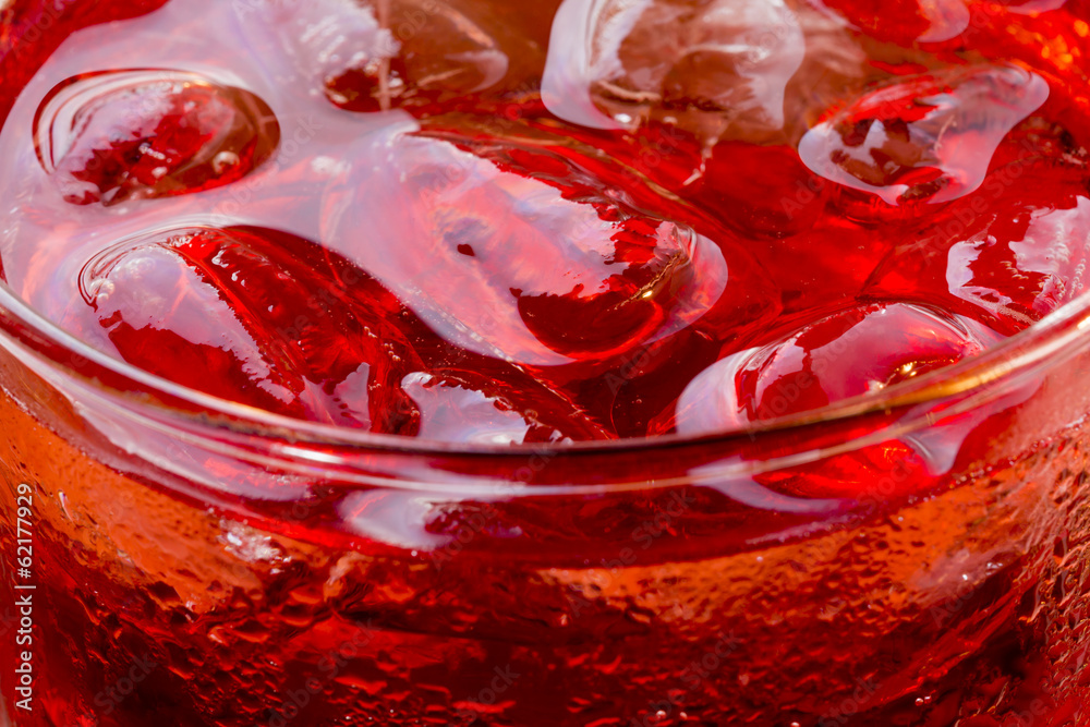 Refreshing: Ice Cubes in a Glass containg Red Drink