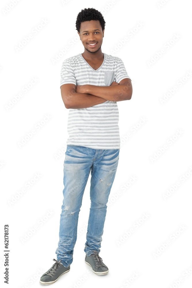 Full length of a smiling young man with arms crossed Full length of a smiling young man with arms crossed