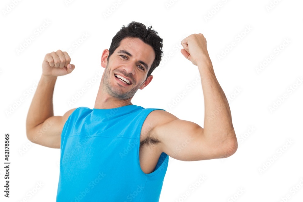 Portrait of a smiling young man flexing muscles Portrait of a smiling young man flexing muscles