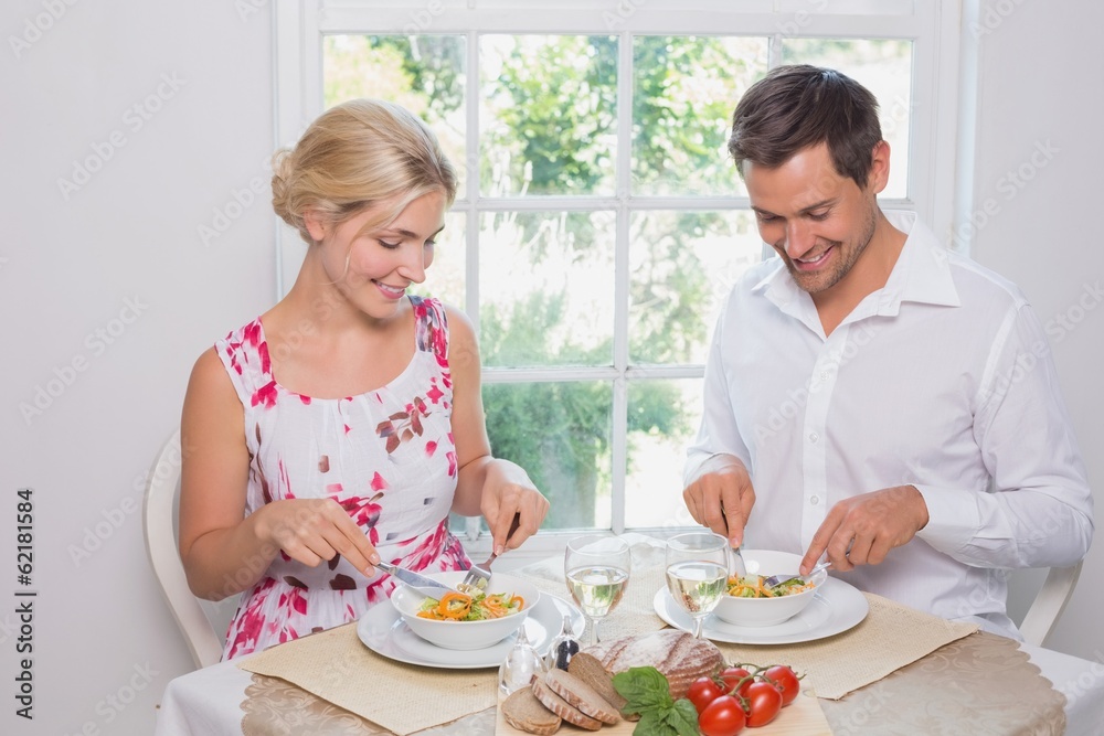 Happy young couple having food