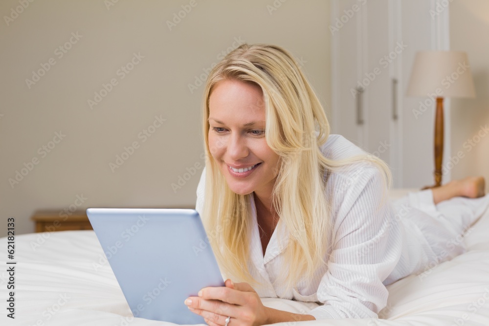 Woman using digital table while lying in bed Woman using digital table while lying in bed