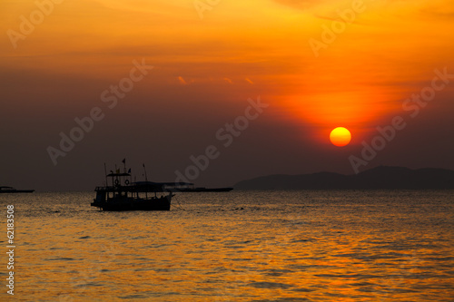 Fishing boat   in Thailand. Silhouette of Fishing Boat on Sunris © EwaStudio