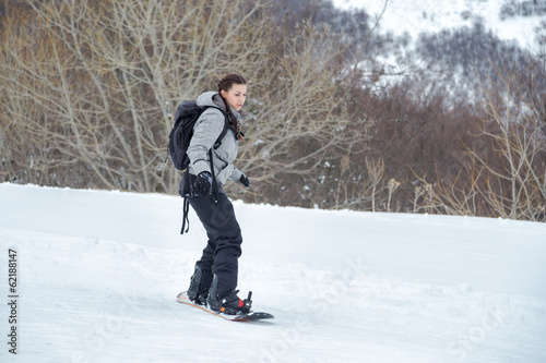 Beginner snowboarder is learning the backside position