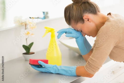 Portrait of frustrated housewife in the middle of cleaning work