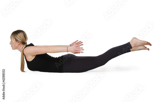 Beautiful young woman in great shape practicing yoga