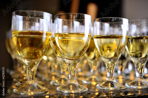 Closeup of glasses of white wine in a row on a table