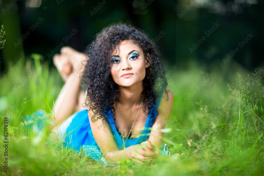 Young relaxing female lying on her stomach in the grass Young relaxing female lying on her stomach in the grass